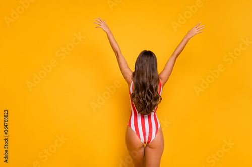 Rear back behind view of nice-looking attractive alluring fit thin slim slender sporty juicy girl model posing rising hands up exotic tour isolated bright vivid shine vibrant yellow color background