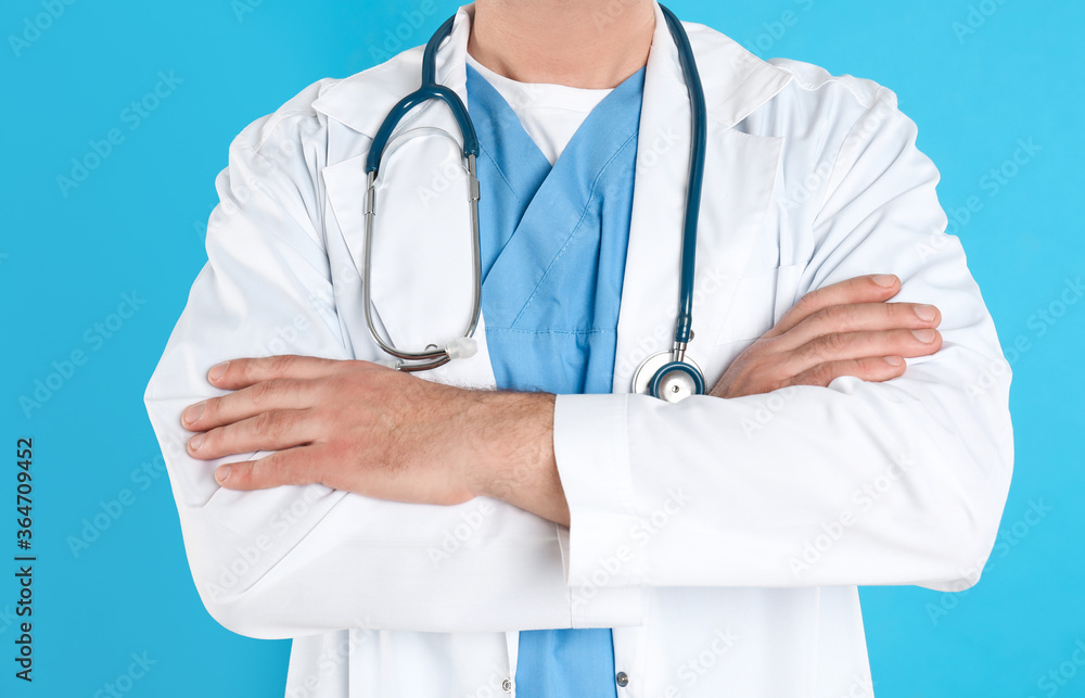 Mature doctor with stethoscope on blue background, closeup Mature doctor with stethoscope on blue background, closeup