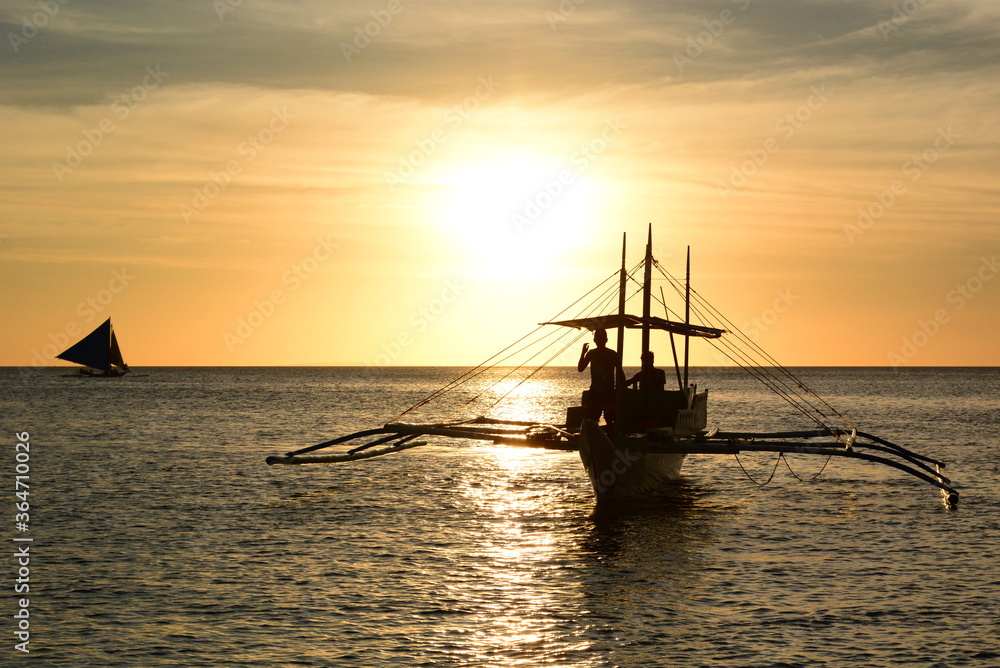 Fishing boat silhouette at sunset. Boracay island. Western Visayas. Philippines