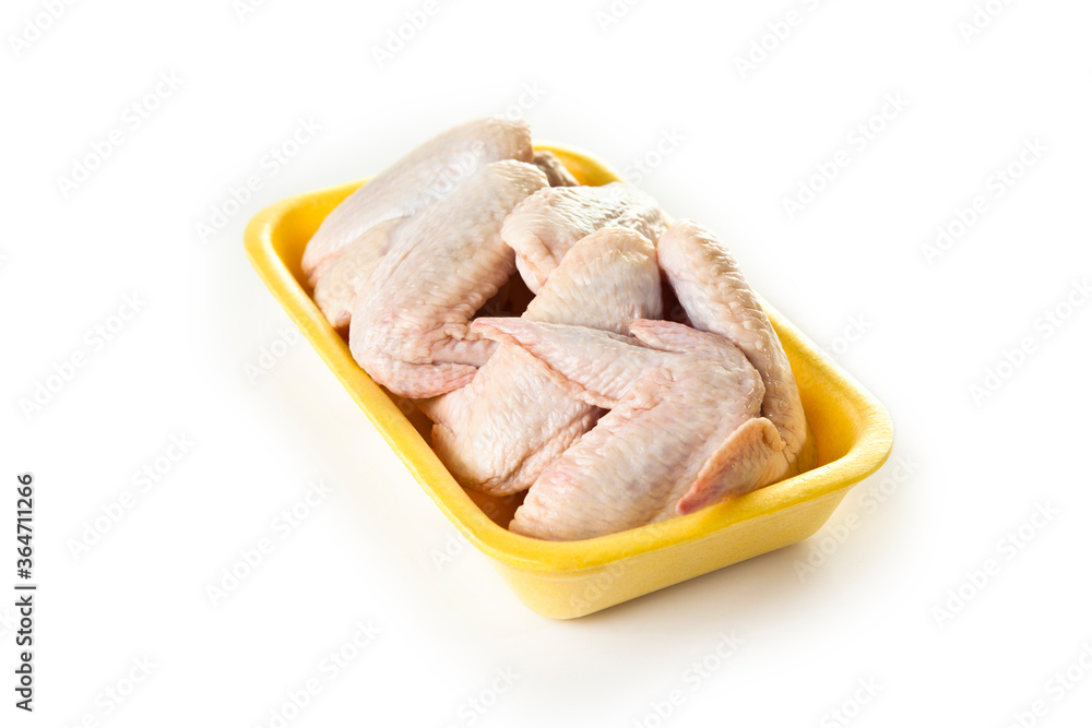 fresh raw chicken wings in yellow foam isolated in white background