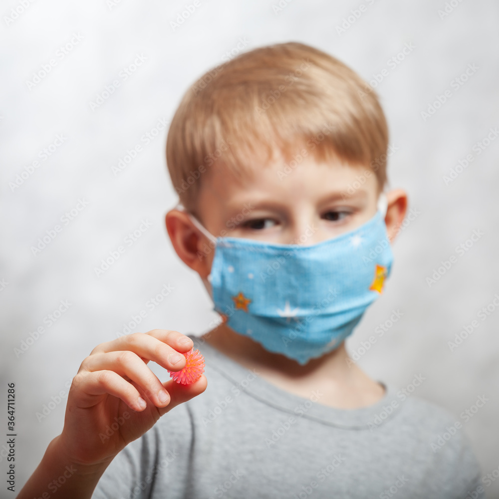 Portrait of a boy in a mask. The concept of a person is protected against coronavirus. Pandemic.