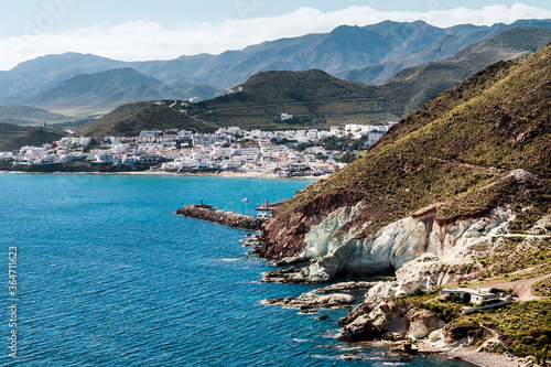 View of the cliffs and mountains surrounding the coastal village of San José at the Cabo de Gata-Níjar Natural Park, Almeria province, Andalusia, Spain
