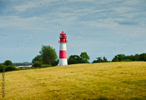 A small and beautiful lighthouse in daylight in Falshöft, Germany