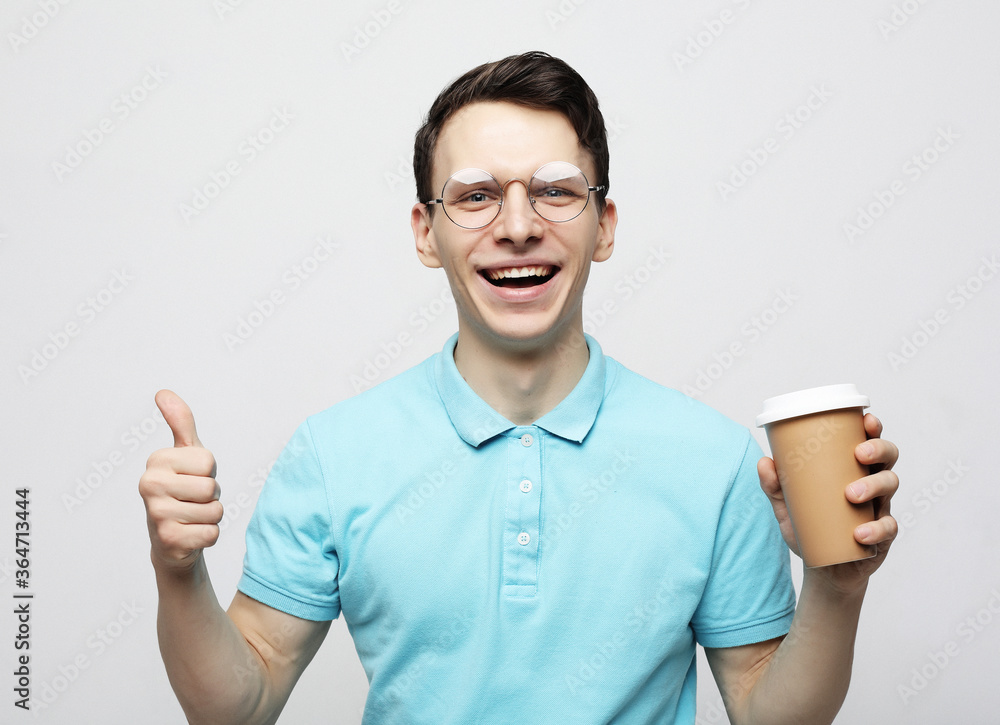 Hipster man standing with takeaway coffee Hipster man standing with takeaway coffee