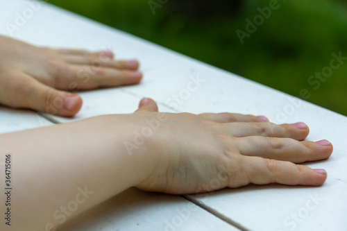 children's hands on a white surface © Elena