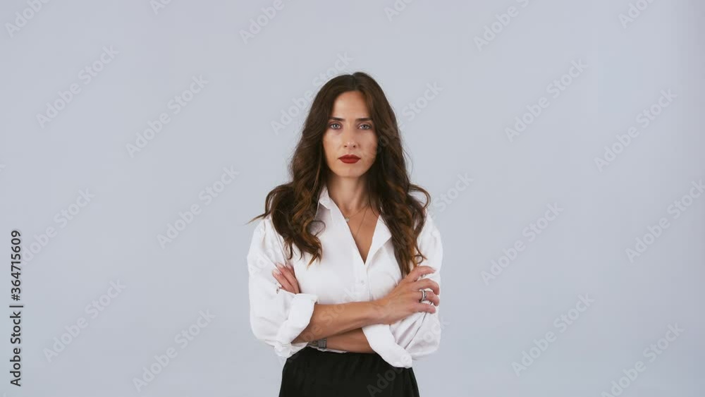 Woman director in white shirt is holding white paper sheets and throwing them up. Looking angry and upset. Posing on gray background. Close up Woman director in white shirt is holding white paper sheets and throwing them up. Looking angry and upset. Posing on gray background. Close up