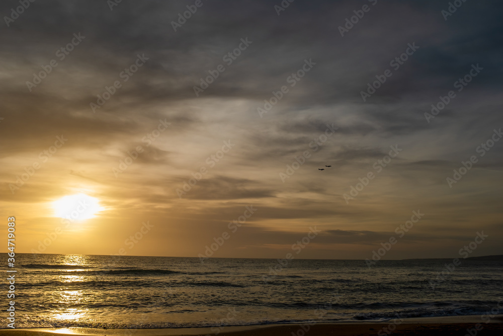 Scenic colorful sunset at the sea coast. Good for wallpaper or background image Radiant sea beach sunset Panoramic photo .Sunset sea horizon sky clouds. Sea sand beach