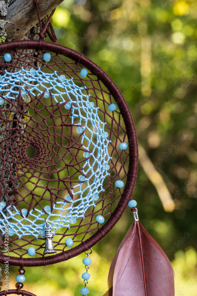 Naklejka premium Handmade dream catcher with feathers threads and beads rope hanging
