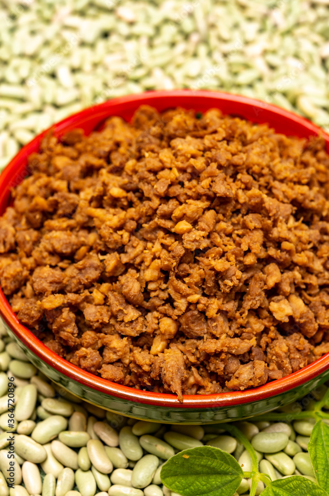 Love vegan and vegetarian food concept, plant based minced meat in plate on soya beans background Love vegan and vegetarian food concept, plant based minced meat in plate on soya beans background