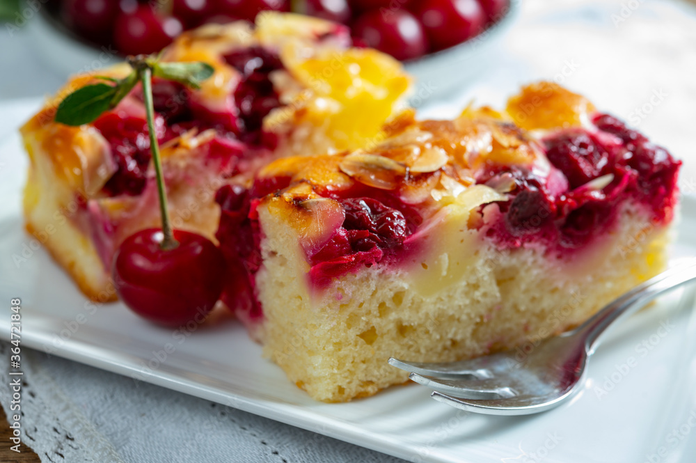 Fresh baked cake with red ripe juicy sour cherry or kriek berry Fresh baked cake with red ripe juicy sour cherry or kriek berry
