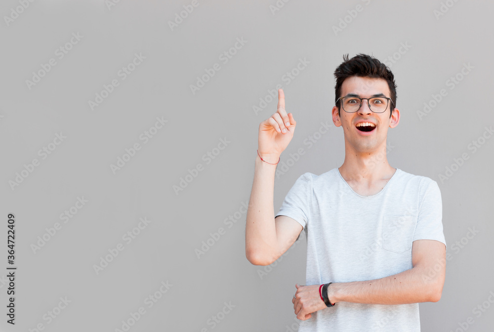 Young man pointing up, showing something, having an idea Young man pointing up, showing something, having an idea