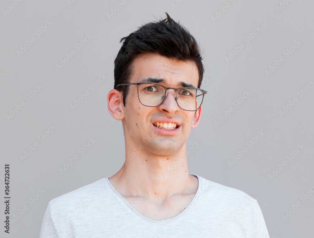 Close up of a doubtful young man Close up of a doubtful young man