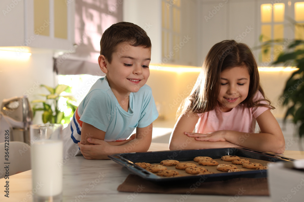 Cute little children with cookies and milk in kitchen. Cooking pastry Cute little children with cookies and milk in kitchen. Cooking pastry
