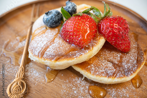 Honey pancake with strawberry and blueberry on top