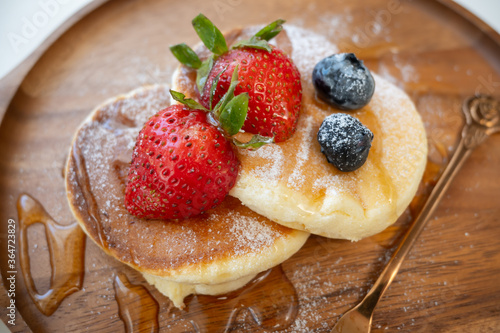 Honey pancake with strawberry and blueberry on top