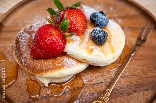 Honey pancake with strawberry and blueberry on top