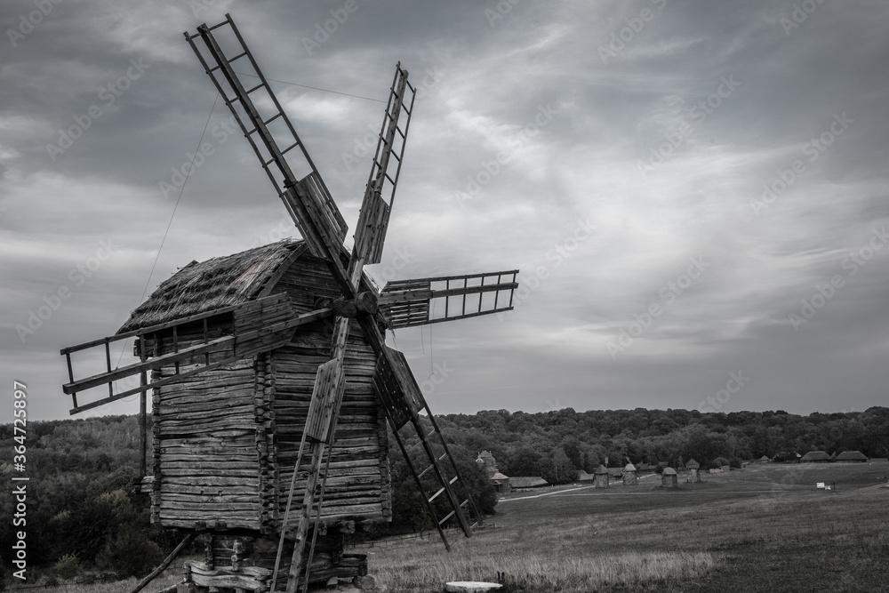 old windmill in the village black and white