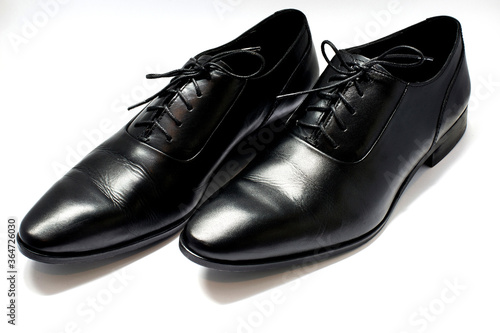 A pair of leather elegant shoes on a white background © PaulPetrut