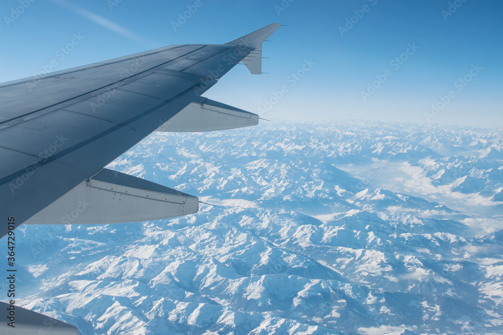 Fototapeta premium Flying over the snowy mountains