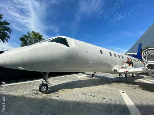 A man near a white plane. Blue sky. Journeys.