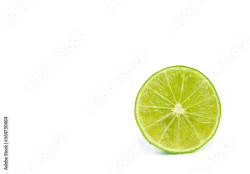green lemon and slice isolated on white