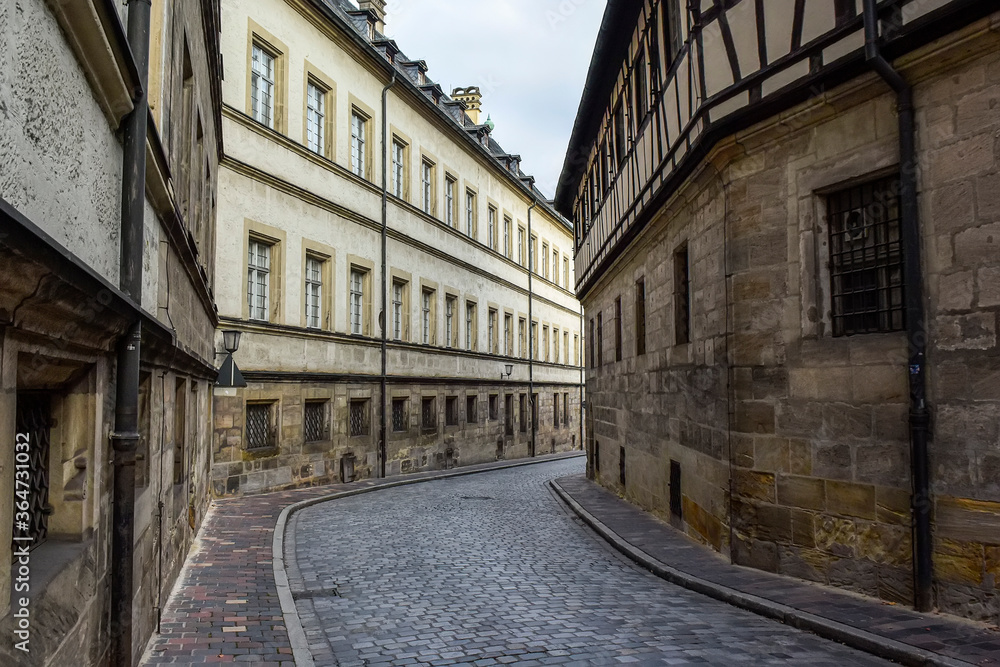 Obraz premium Narrow medieval street with traditional Bavarian houses in Bamberg, Bavaria, Franconia, Germany. November 2014
