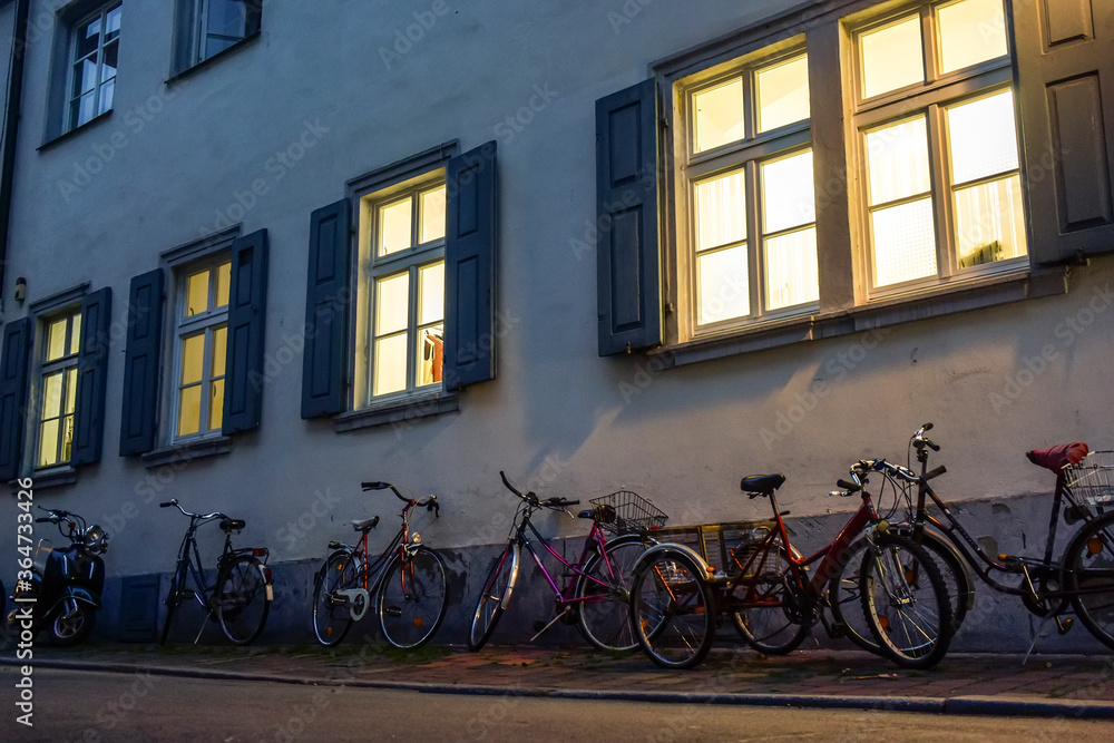 Bicycles parked on narrow medieval street with traditional Bavarian houses in Bamberg, Bavaria, Germany. November 2014