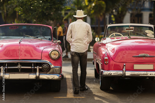 Photography Amazing old american car on streets of Havana with colourful buildings in background