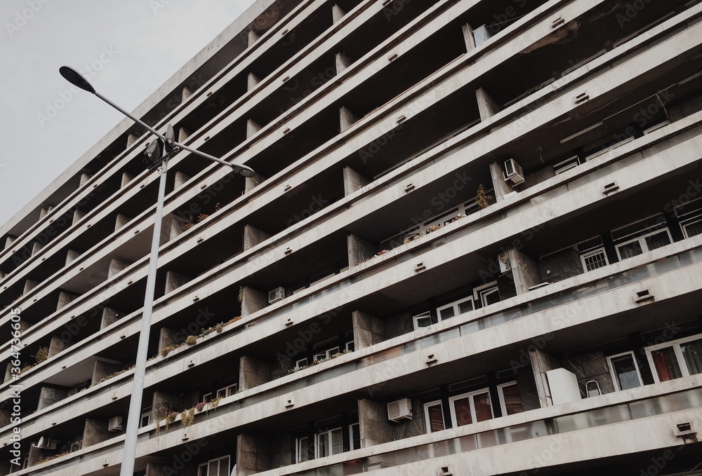 Old facade of a residential building with balconies. The gray building. High quality photo