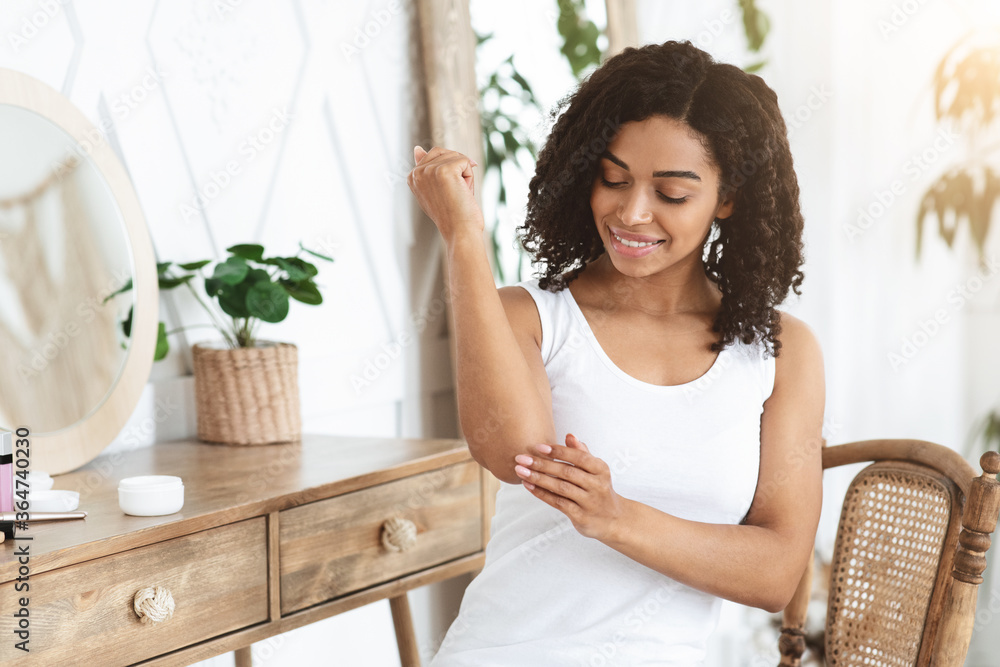 Dry Elbows Treatment. Smiling Black Woman Applying Moisturising Cream At Home Dry Elbows Treatment. Smiling Black Woman Applying Moisturising Cream At Home