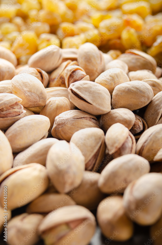 Closeup view at pistachio nuts on kitchen table. Vegetarian food concept