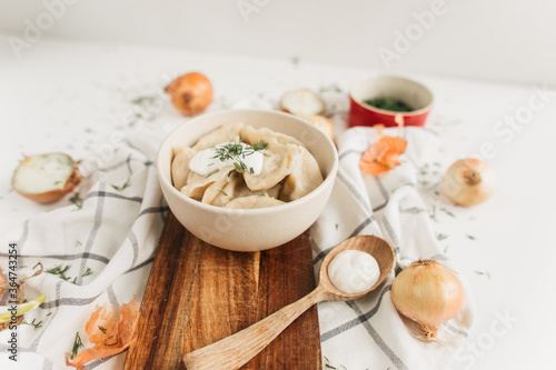 dumplings with potatoes and onions with sour cream and herbs