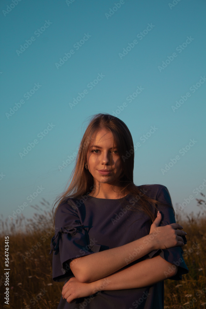 Portrain beautyful woman outdoors at sunset time. Gold light in a field Portrain beautyful woman outdoors at sunset time. Gold light in a field