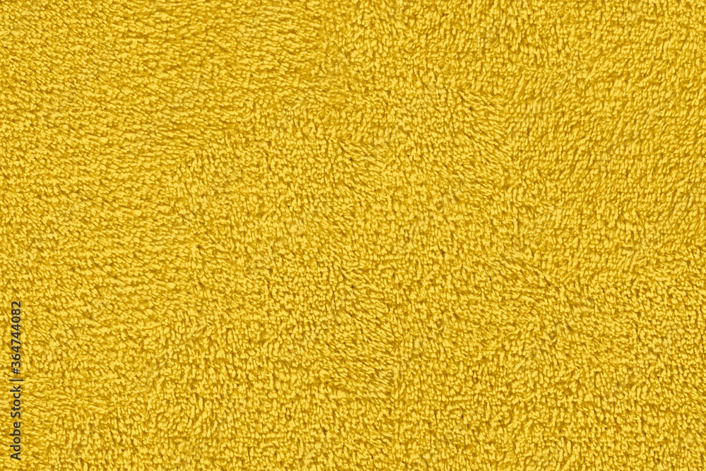 Fototapeta premium Yellow natural cotton towel background, close-up yellow towel texture.