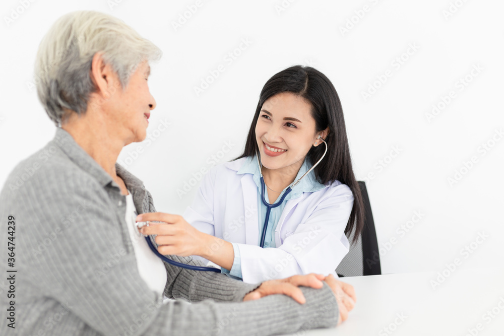 Asian doctor talk with old female patient about disease symptom, doctor use stethoscope listening lung of patient, elderly health check up, happiness hospital Asian doctor talk with old female patient about disease symptom, doctor use stethoscope listening lung of patient, elderly health check up, happiness hospital