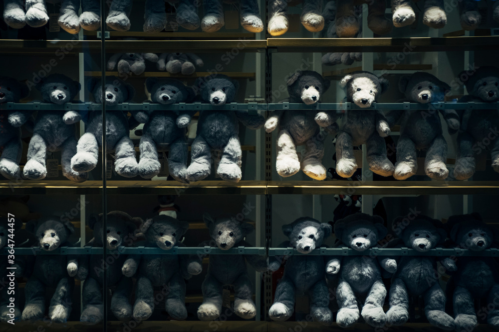 grey teddy bear display on shelves in the retail shop