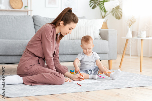 Home Activities With Babies. Mom And Her Cute Toddler Baby Drawing Together