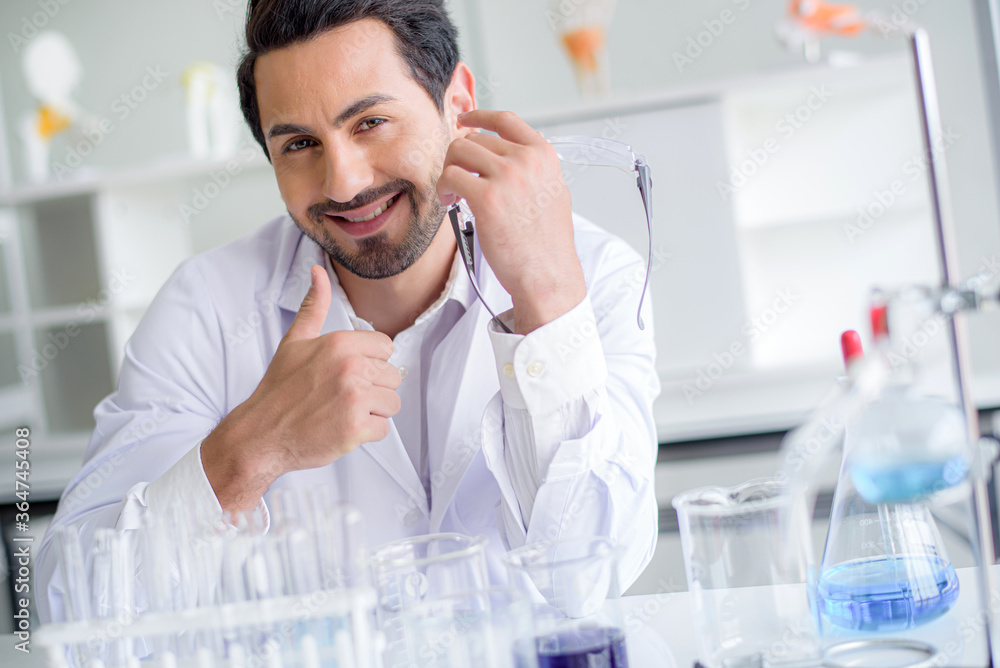 Happy Caucasian scientist man lab technical service observe liquid sample with lab glassware and test tubes in chemical laboratory background, science laboratory research and lab development concept Happy Caucasian scientist man lab technical service observe liquid sample with lab glassware and test tubes in chemical laboratory background, science laboratory research and lab development concept