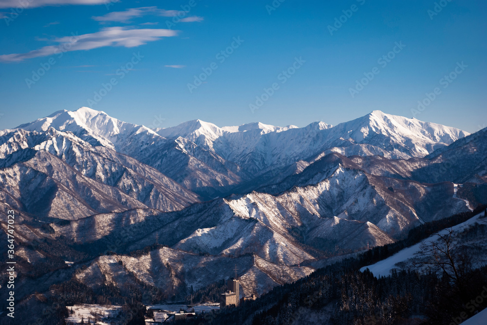 white snow and beautiful landscape during winter season in Japan against blue sky background