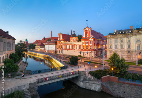 Wroclaw, Poland. Embankment of Odra river near Tamka island with St. Maciej bridge and historic former building of the Order of Hospitallers 