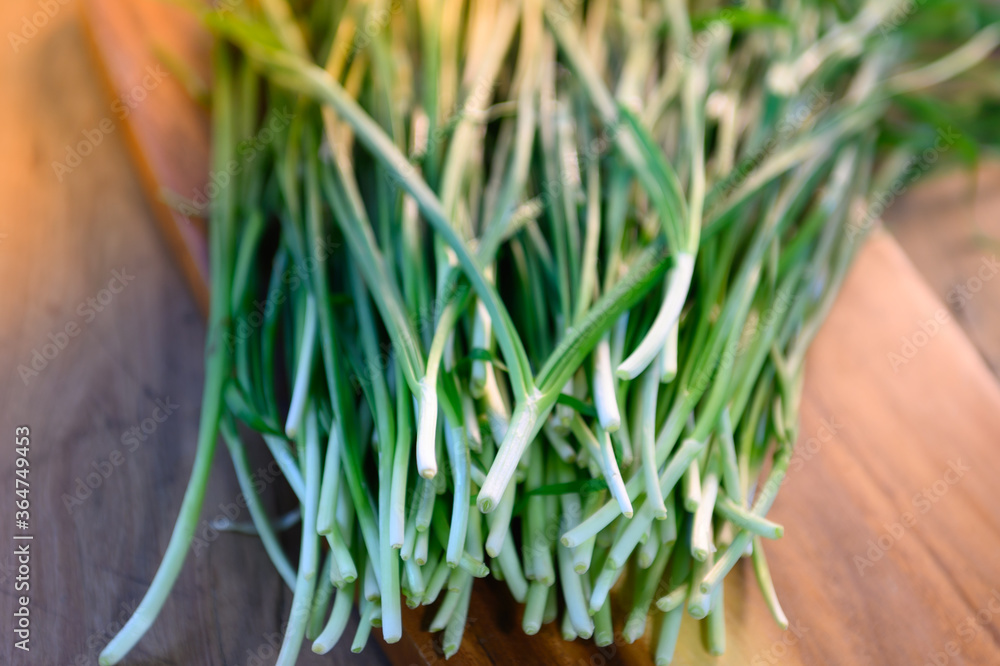 The chives are prepared on a wooden cutting board. For cooking The chives are prepared on a wooden cutting board. For cooking