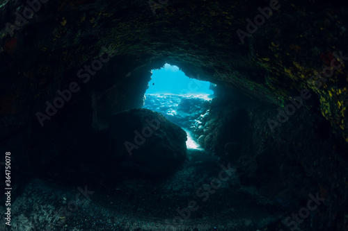 Underwater scene with tunnel cave in ocean
