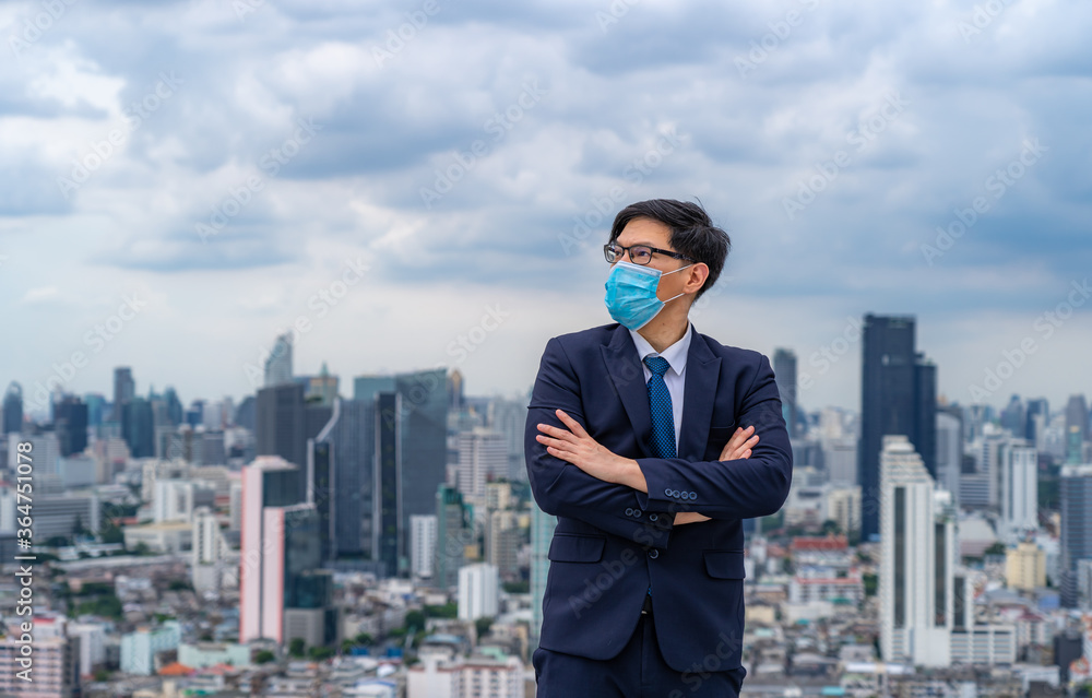 Young businessman wear masks to prevent dust and toxic pollution from the air, smoke and viral diseases,Perspectives on the future and success Young businessman wear masks to prevent dust and toxic pollution from the air, smoke and viral diseases,Perspectives on the future and success
