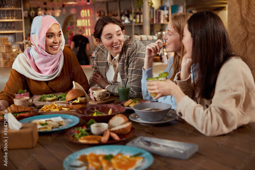 Lunch. Women Eating Food In Cafe. Group Of Multi-Ethnic Girls Having Breakfast And Talking. Friends Meeting In Restaurant As Part Of Urban Lifestyle.