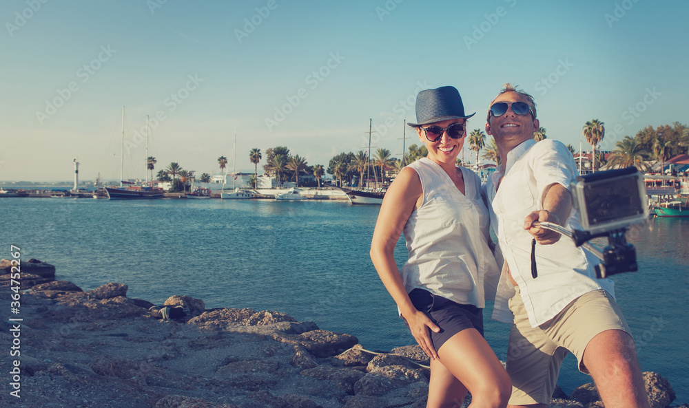 Funny couple take vacation selfie on the sea bay. Summer vacation concept image.