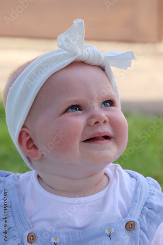 Baby girl seven months old full face image blue eyes blonde hair 