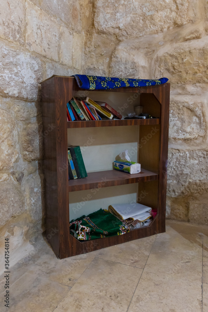 Foto de Bookcase with holy books and prayer accessories in the burial