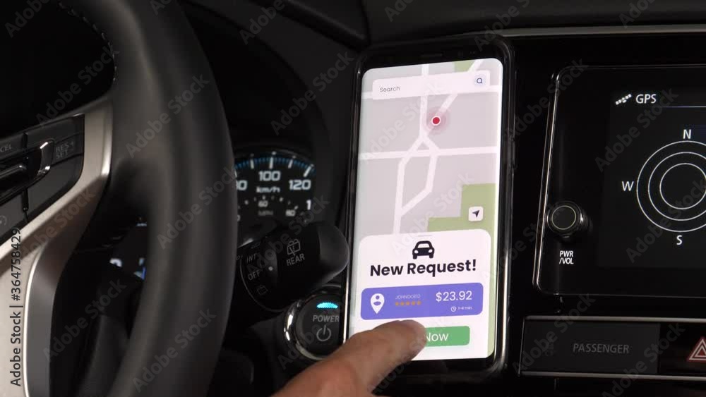 Car driver for a ride sharing service using his mobile phone to receive ...