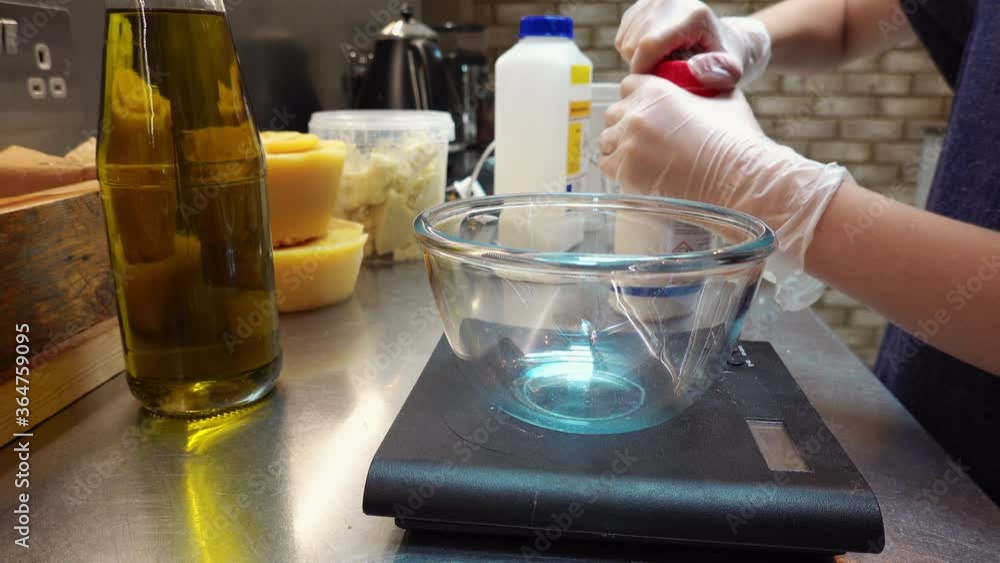CU Boy (10-11) making soap, pouring ingredient into bowl on kitchen scale / UK CU Boy (10-11) making soap, pouring ingredient into bowl on kitchen scale / UK