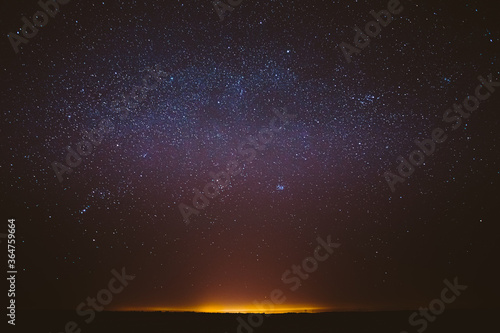 Real Night Sky Stars Background With Natural Colourful Sky Gradient. Sunset  Sunrise Light And Starry Sky. Yellow And Black Colors